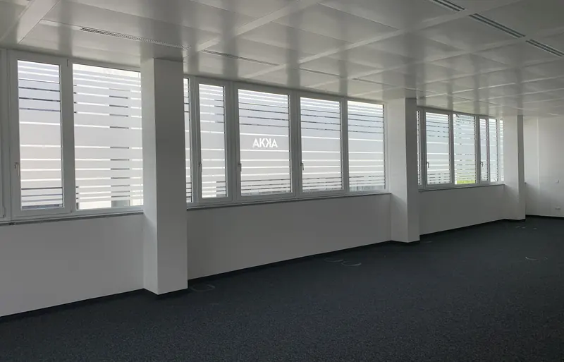 Büroräume mit Fensterband, Sichtschutzfolie in Streifen und ausgespartem Firmenlogo